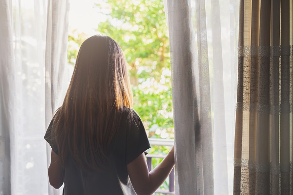 Young woman gazing hopefully outside