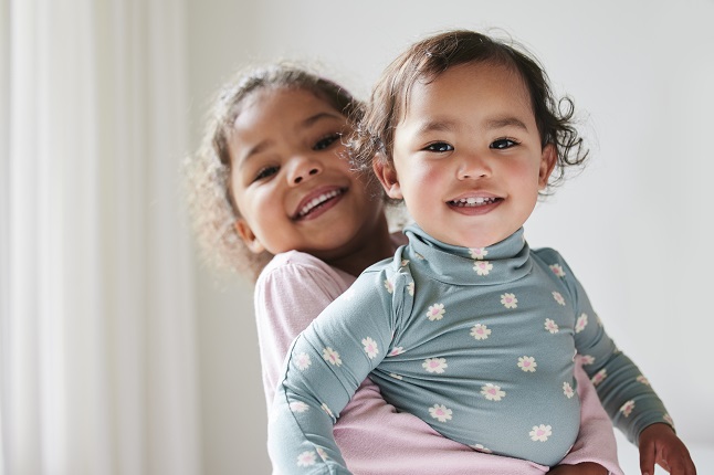 Small girl hugging a smaller girl