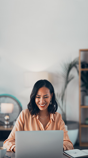 Smiling woman working on her laptop
